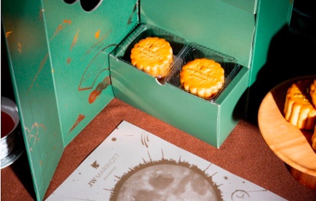 a set of mooncakes in a jade green box